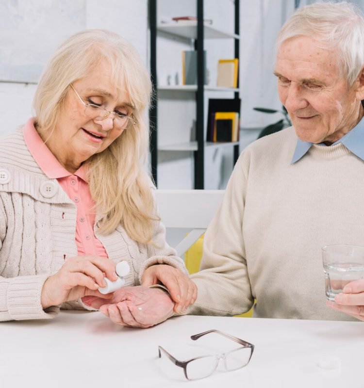 senior-couple-using-pills_23-2148014586
